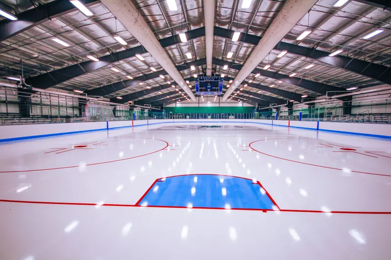 Freshly painted blue line and face-off circle on a new indoor ice sheet