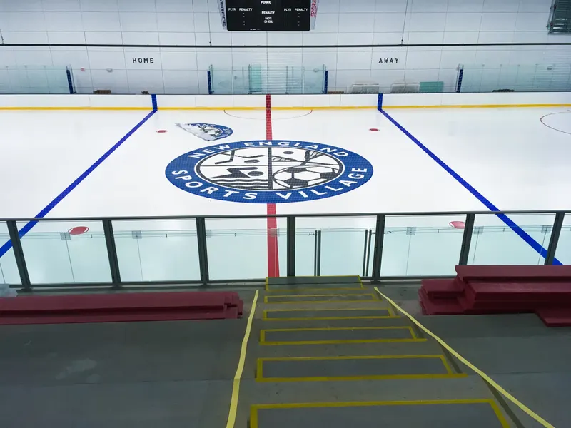 View from the players bench across center ice through the dasherboard glass