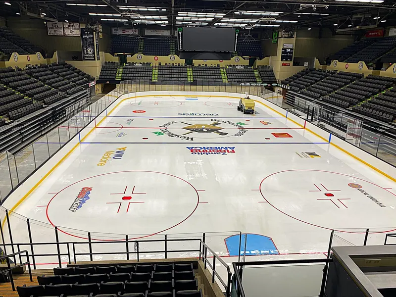 Wide view of an arena from the seating bowl with the ice sheet fully marked