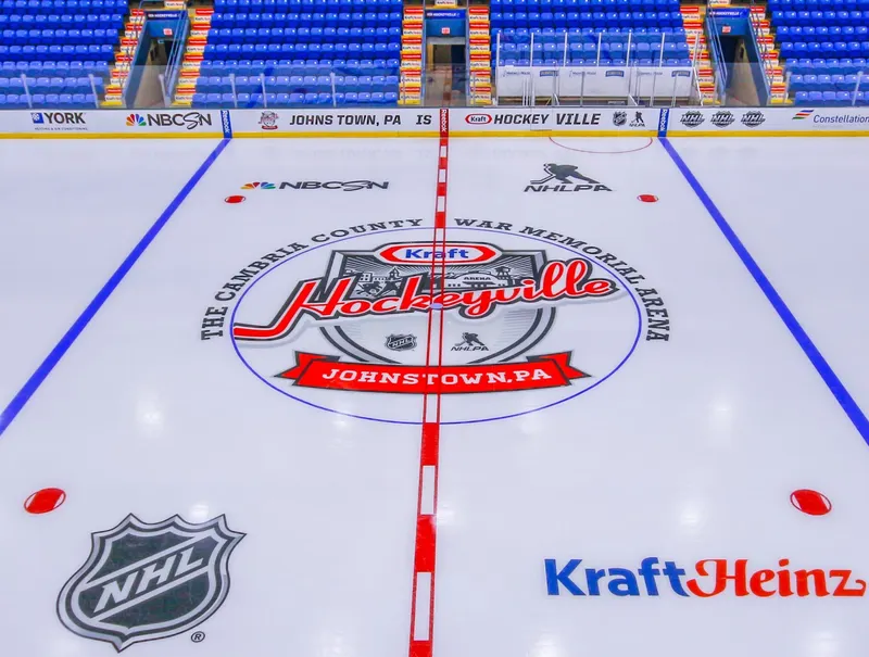 Center ice of a small-town arena painted for a nationally televised hockey event