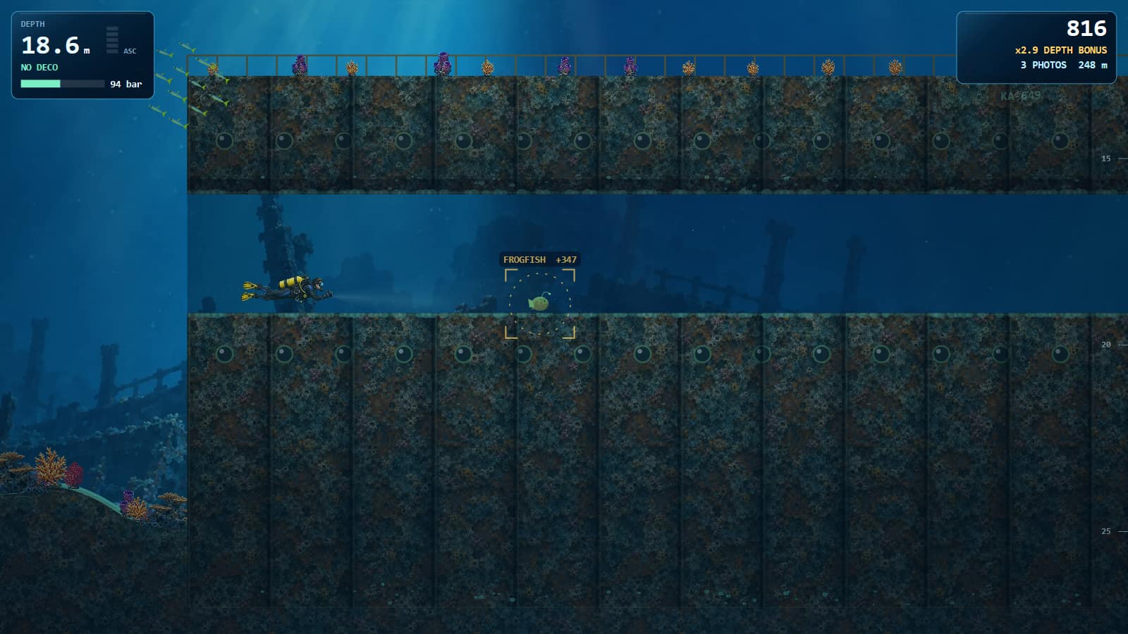 A diver above a sunken ship hull with portholes and sponges on the deck; below the deck a swim-through, where a viewfinder ring marks a frogfish worth 332 points